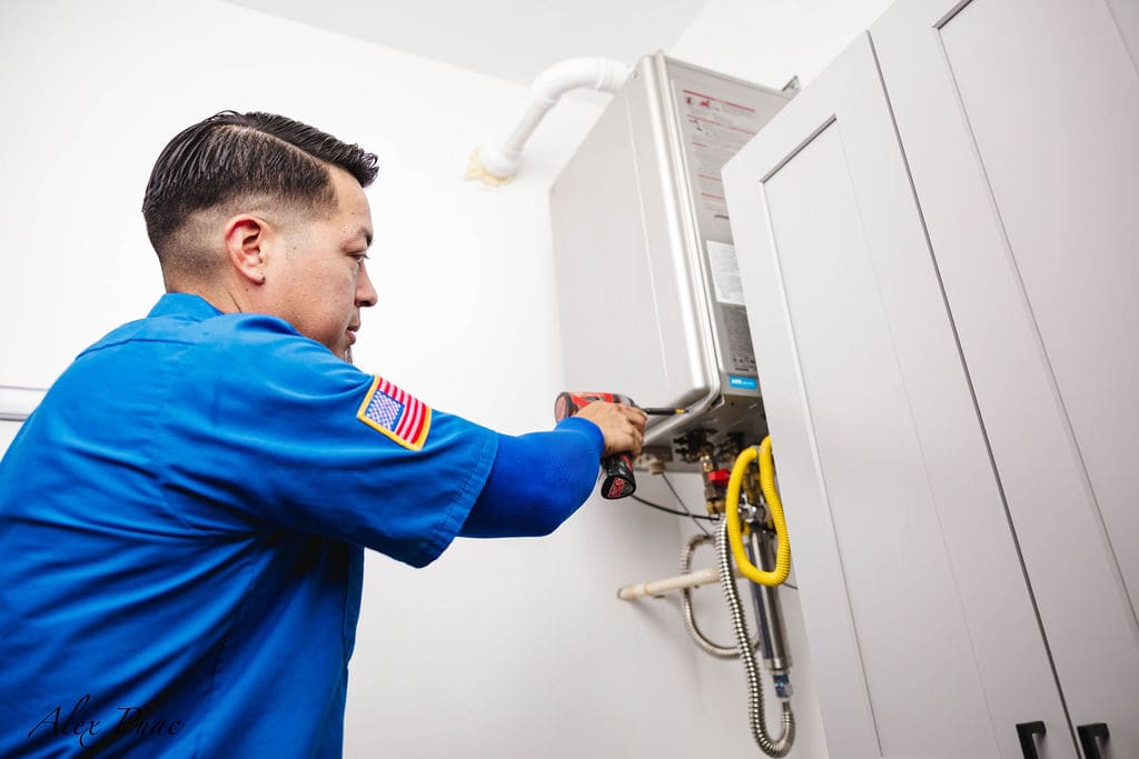 Hugo Plumbing technician installing a tankless water heater